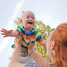 woman lifting baby